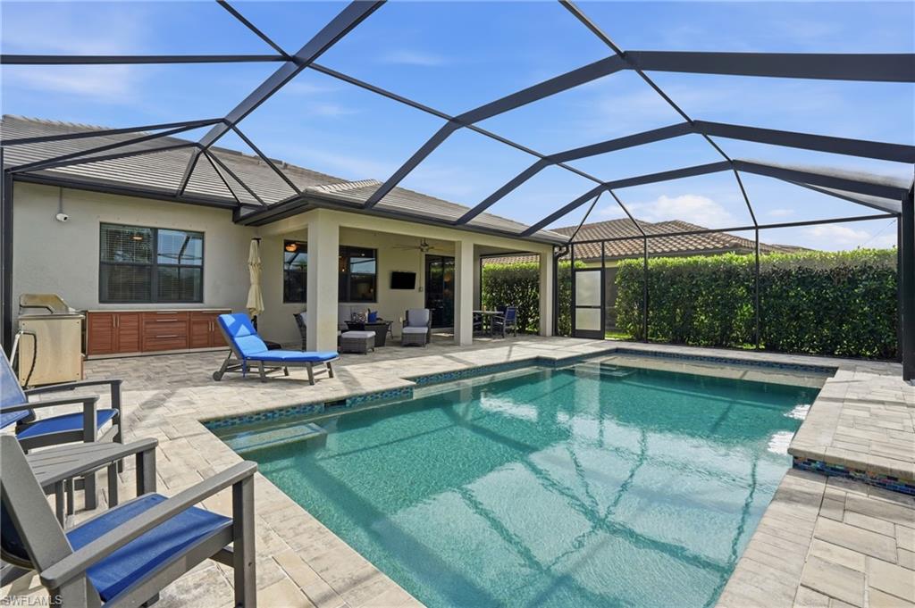 19906 Beverly Park Road Estero, FL 33928 - Photo 46 of 50 a view of a patio with a table and chairs under an umbrella