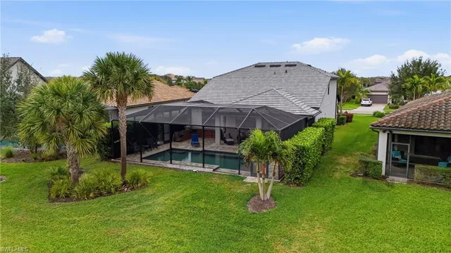 an aerial view of residential houses with outdoor space and lake view