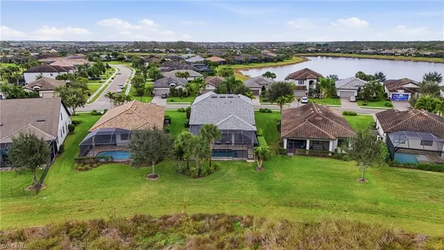 an aerial view of residential houses with outdoor space and river