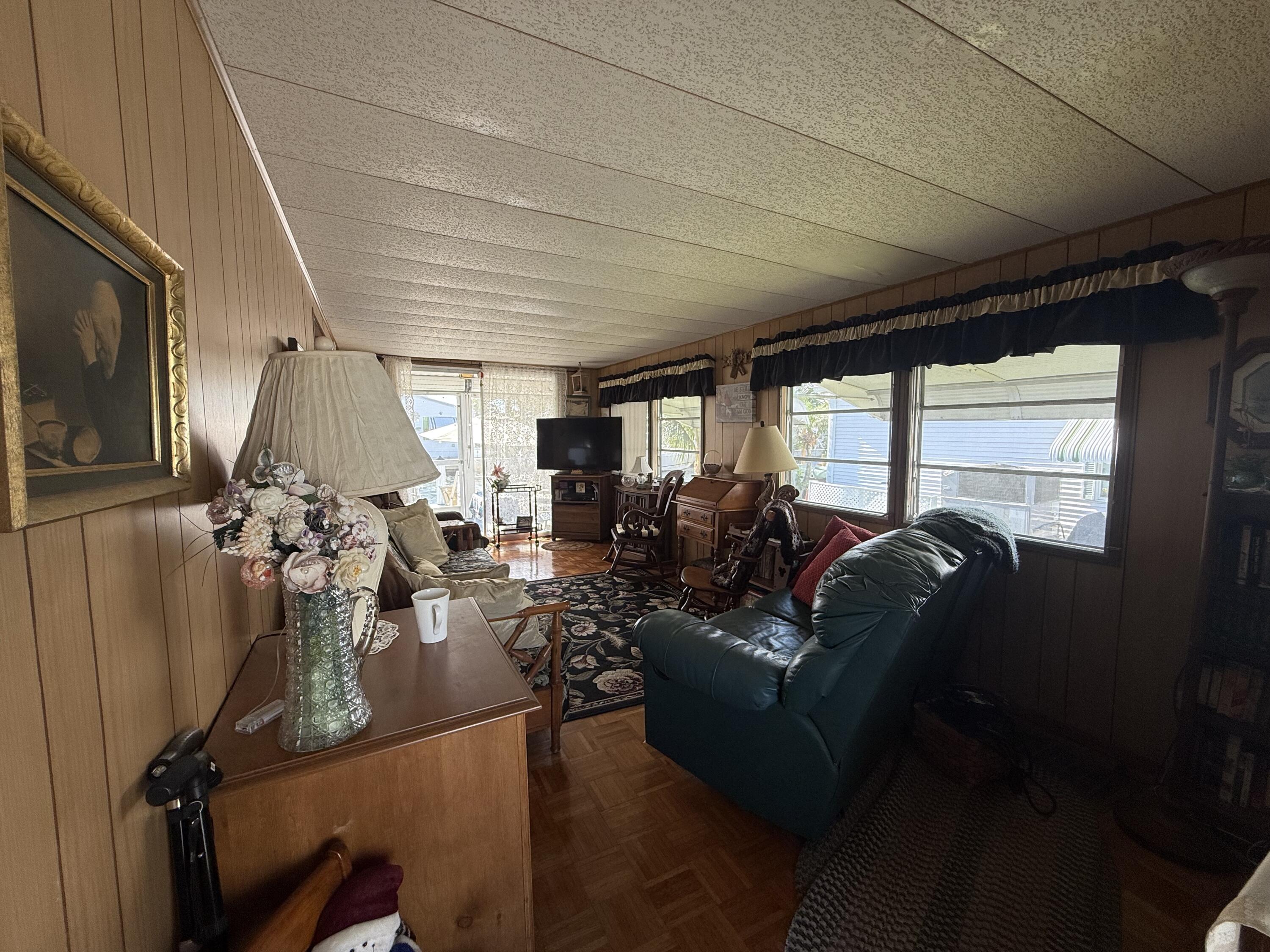 203 South Ibis Drive, Unit R Briny Breezes, FL 33435 - Photo 11 of 24 a living room with furniture a window and gym equipment