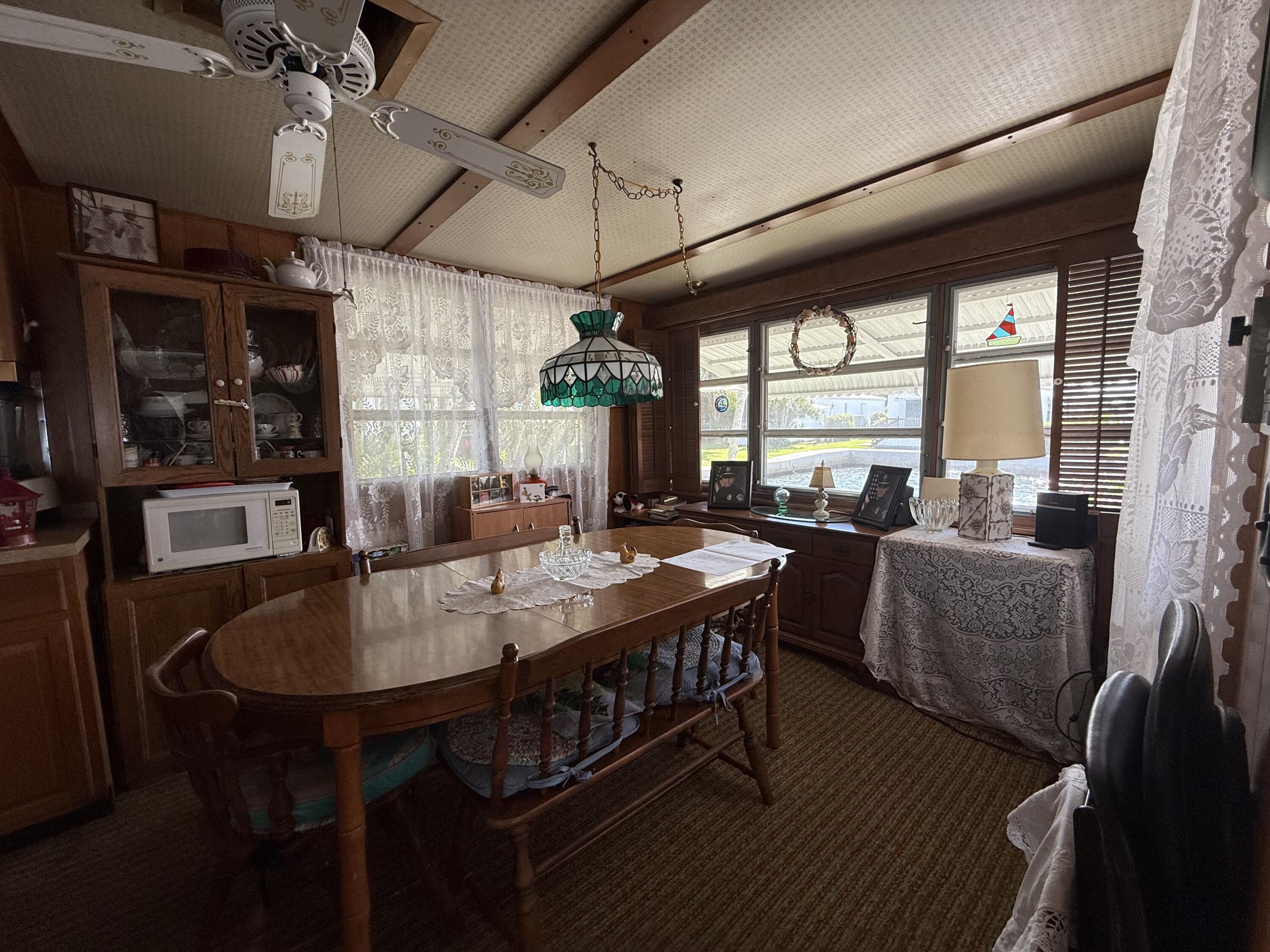 203 South Ibis Drive, Unit R Briny Breezes, FL 33435 - Photo 12 of 24 a view of a dining room with furniture window and outside view