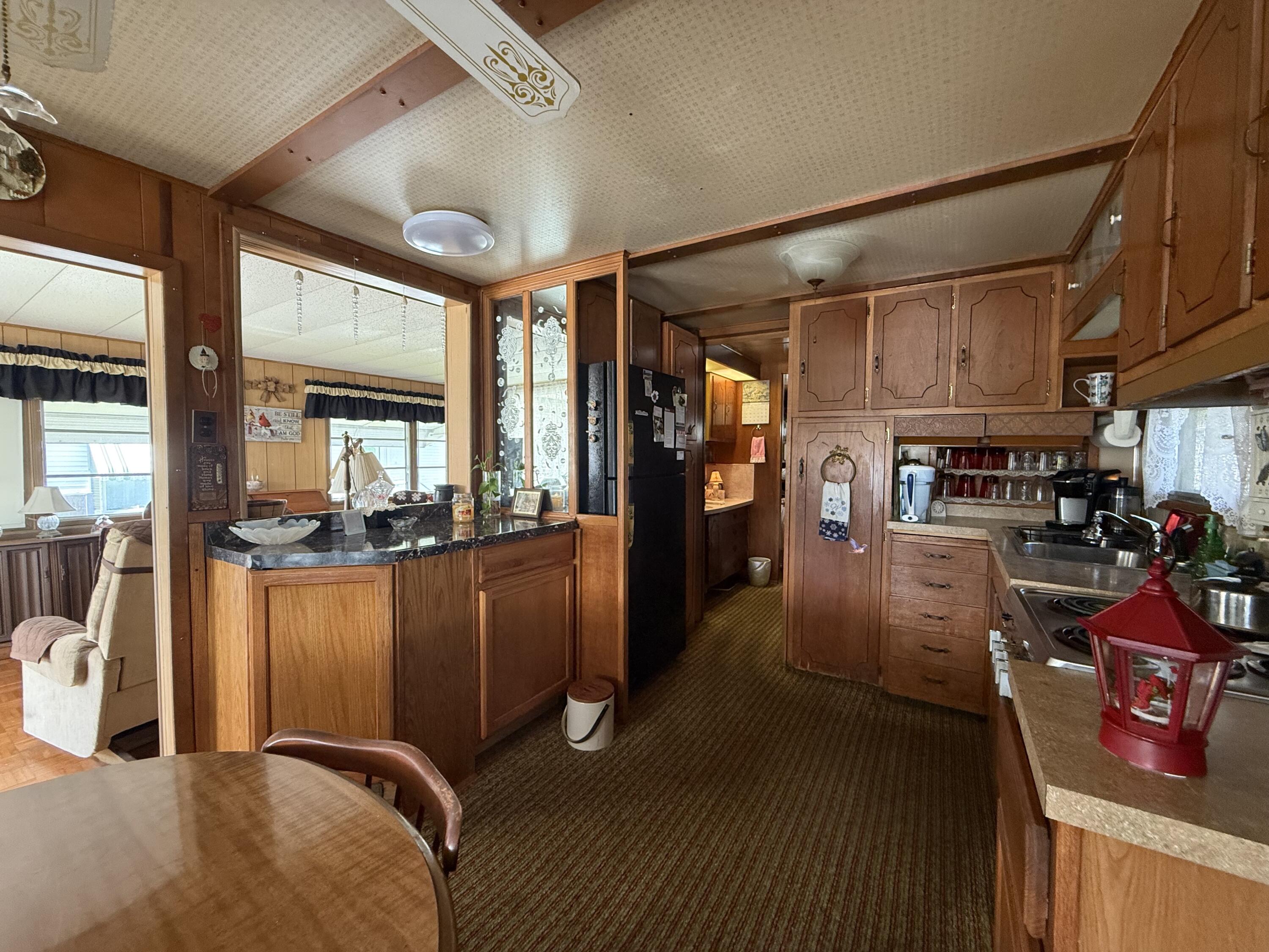 203 South Ibis Drive, Unit R Briny Breezes, FL 33435 - Photo 15 of 24 a living room with stainless steel appliances lots of furniture and a chandelier