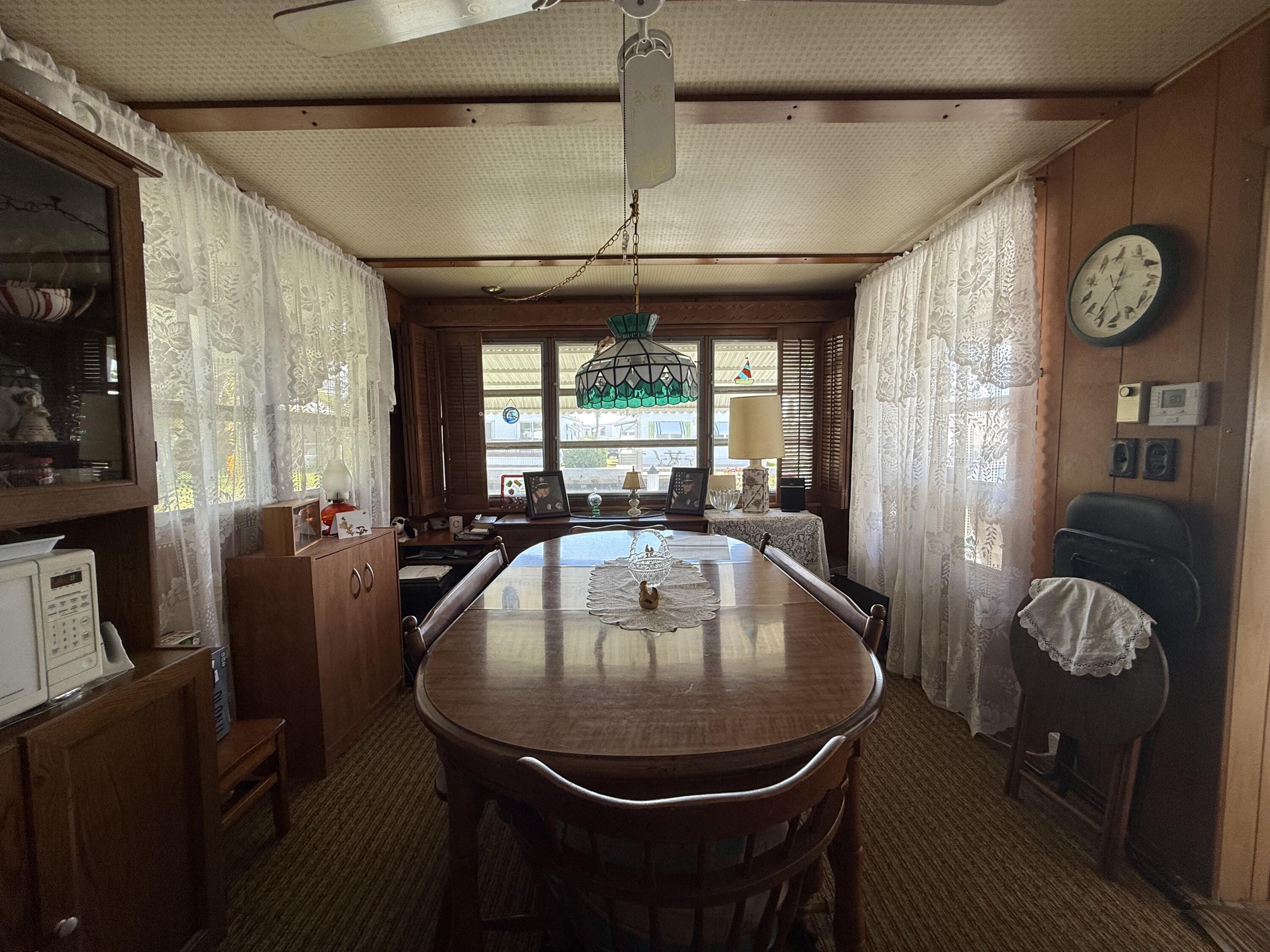 203 South Ibis Drive, Unit R Briny Breezes, FL 33435 - Photo 16 of 24 a view of a dining room with furniture window and chandelier