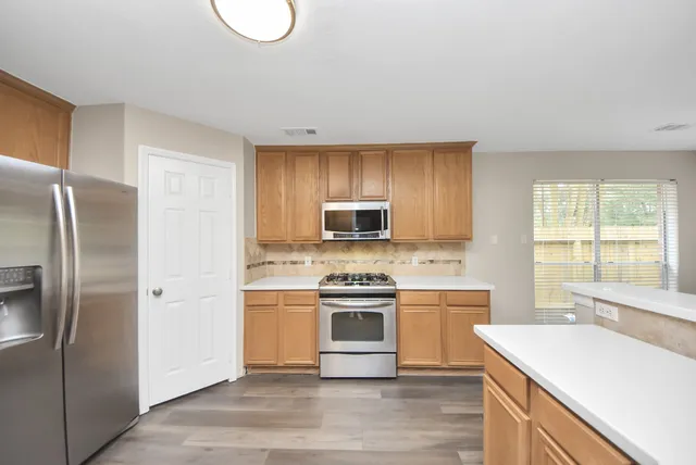 a kitchen with a stove a sink and a refrigerator