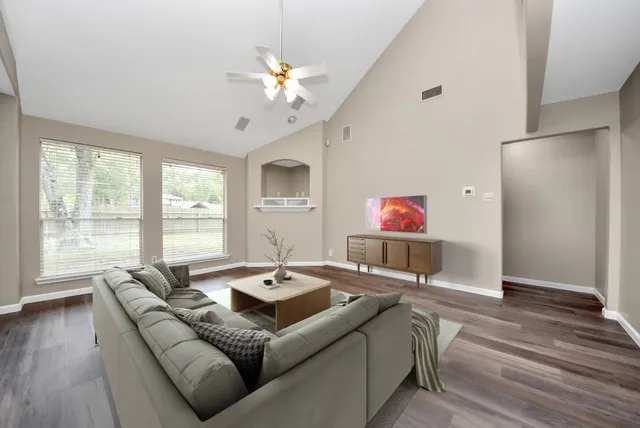 a living room with furniture and a flat screen tv