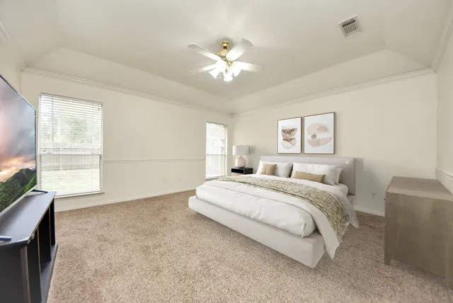 a spacious bedroom with a large bed and a window