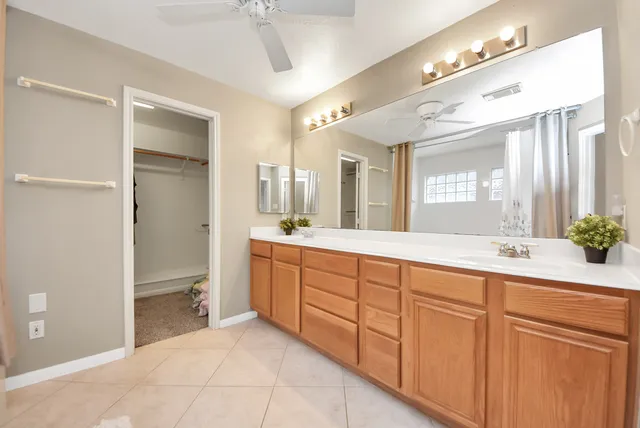 a spacious bathroom with a granite countertop sink mirror and a