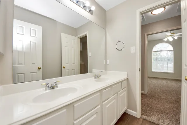 a bathroom with a double vanity sink and a mirror