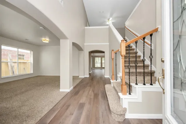 a view of entryway and hall with wooden floor