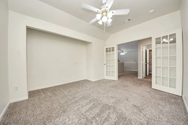 an empty room with a bathroom and a shower