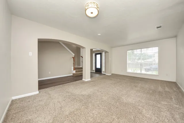 an empty room with windows and closet