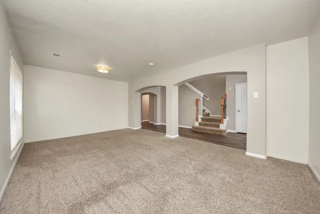 a view of a livingroom and a empty room