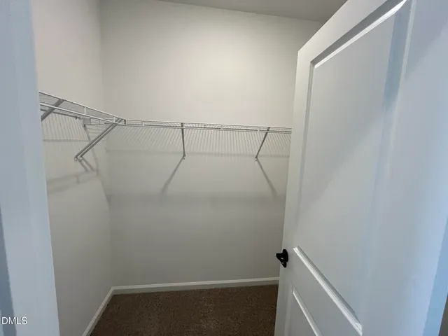 a spacious bathroom with double vanity and a mirror