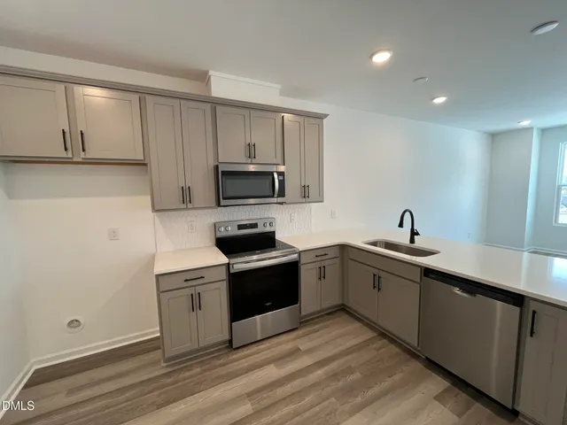 a kitchen with a sink cabinets and stainless steel appliances