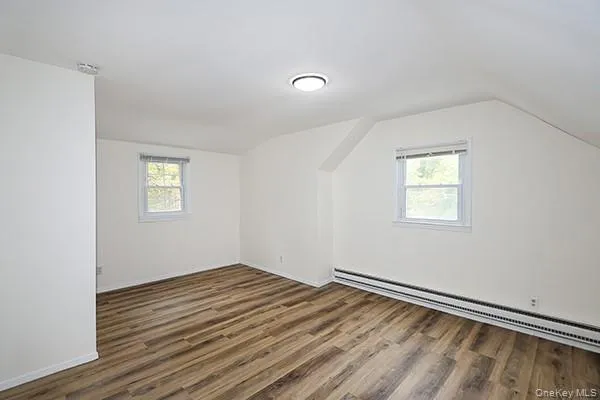 a view of a room with wooden floor and window