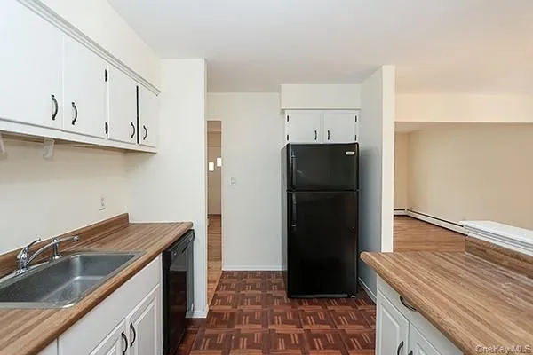 a kitchen with a refrigerator and a sink