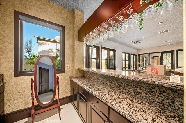 a dining room with furniture a chandelier and kitchen view