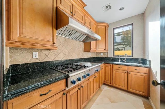 a view of a hallway with a couch and chandelier