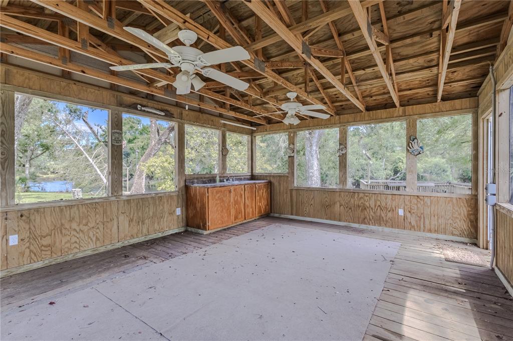 2008 River Road Steinhatchee, FL 32359 - Photo 23 of 41 a view of a room with wooden walls and iron stairs