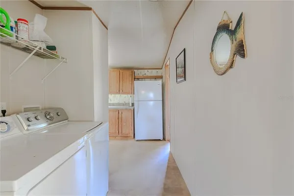 a view of kitchen with refrigerator and window