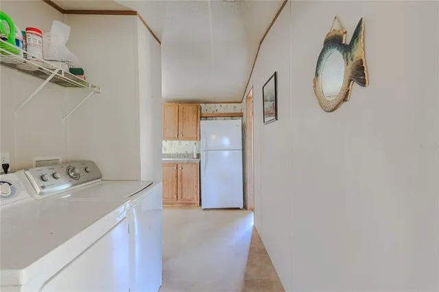 a view of kitchen with refrigerator and window