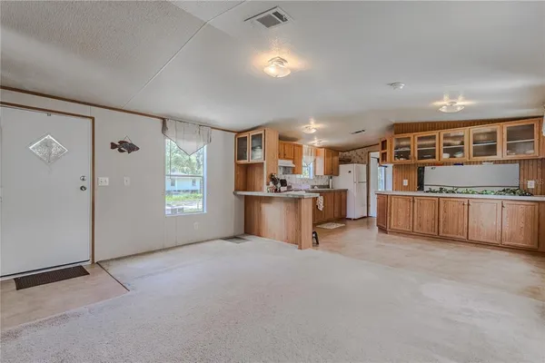 a view of a yard with plants and wooden fence