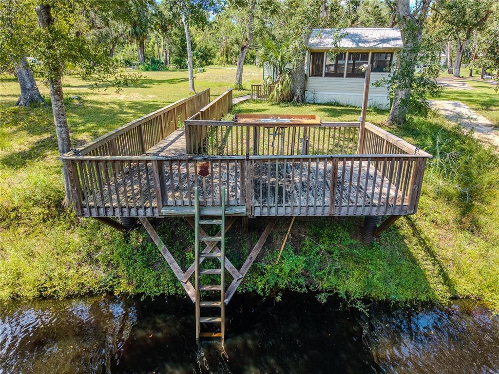 2008 River Road Steinhatchee, FL 32359 - Photo 6 of 41 a view of a roof deck with wooden floor and outdoor seating