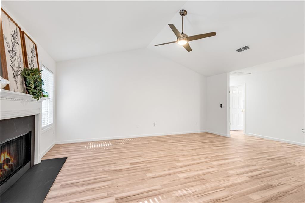 125 Pine Ridge Trace Athens, GA 30605 - Photo 4 of 28 a view of a room with wooden floor and a ceiling fan