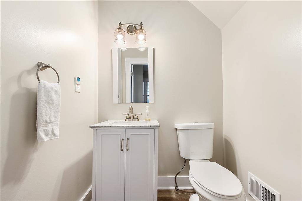 22 Millbridge Street Pittsburgh, PA 15210 - Photo 15 of 25 a bathroom with a toilet a sink and mirror