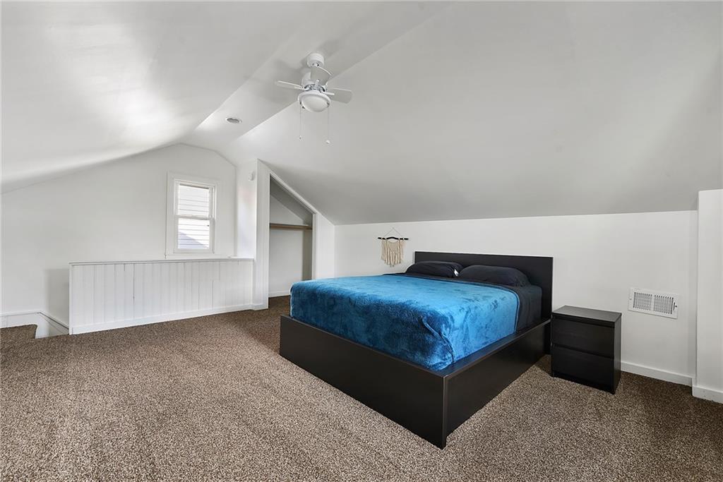 22 Millbridge Street Pittsburgh, PA 15210 - Photo 21 of 25 a bedroom with a bed and window
