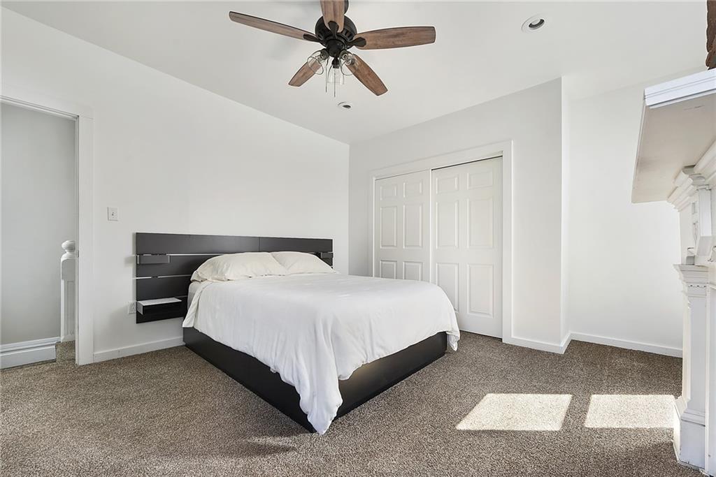 22 Millbridge Street Pittsburgh, PA 15210 - Photo 22 of 25 a bedroom with a bed and ceiling fan