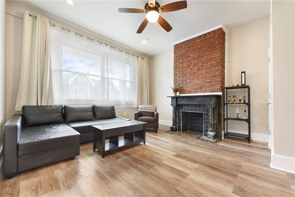 22 Millbridge Street Pittsburgh, PA 15210 - Photo 3 of 25 a living room with furniture and a fireplace