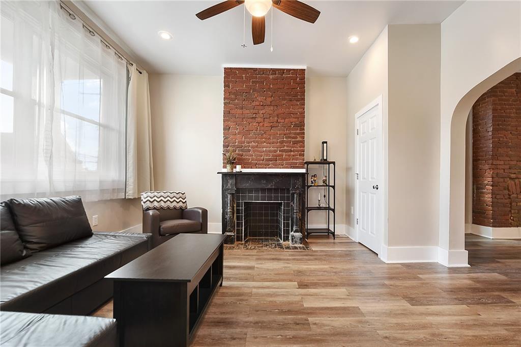 22 Millbridge Street Pittsburgh, PA 15210 - Photo 4 of 25 a living room with furniture and a fireplace