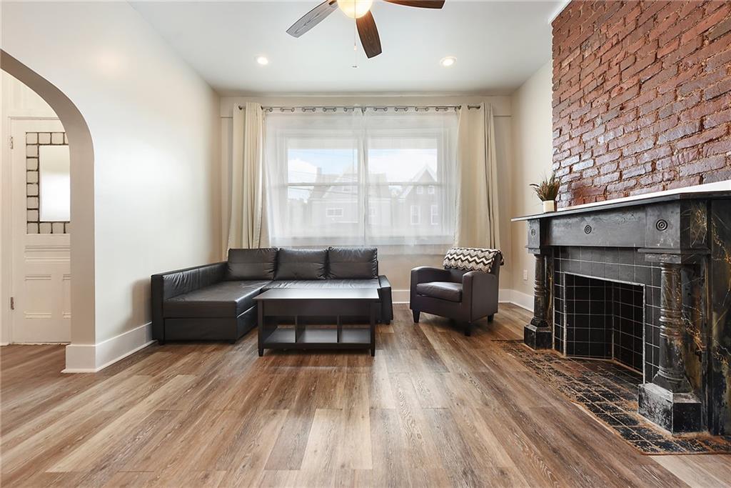22 Millbridge Street Pittsburgh, PA 15210 - Photo 5 of 25 a living room with furniture and a fireplace