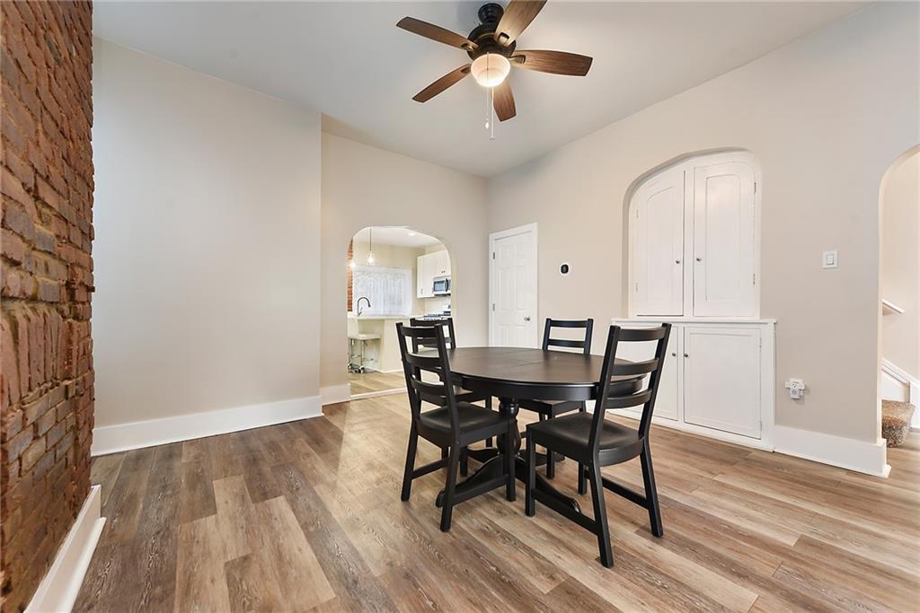 22 Millbridge Street Pittsburgh, PA 15210 - Photo 7 of 25 a view of a dining room with furniture and wooden floor