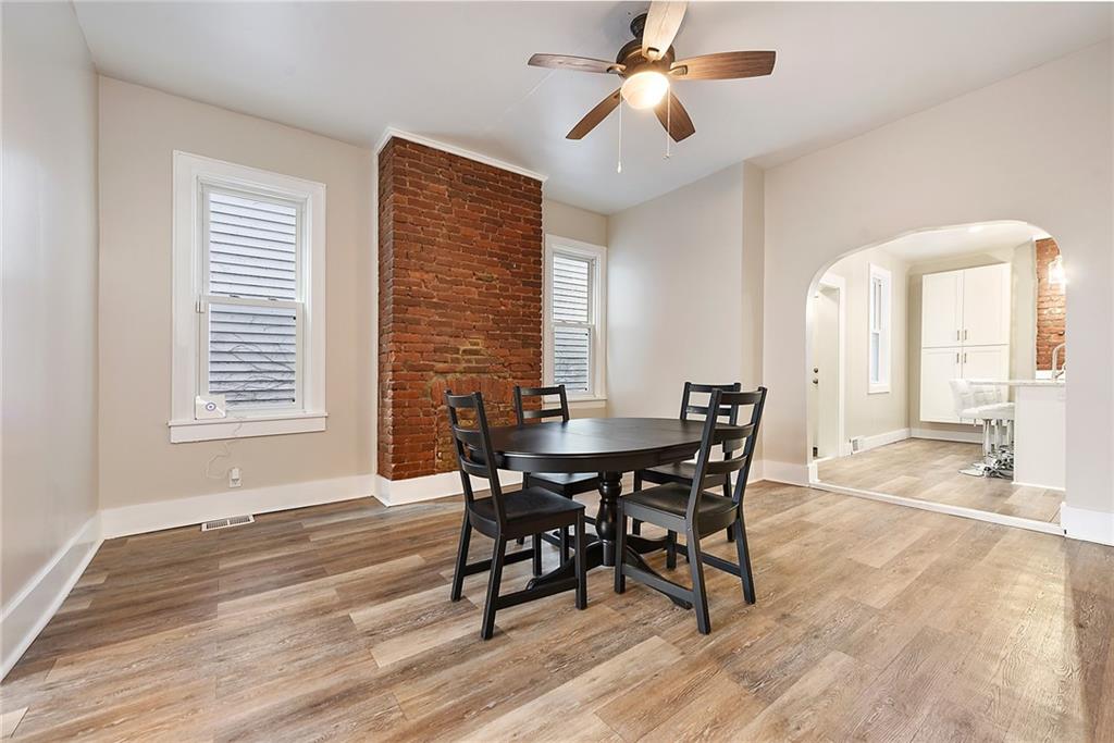 22 Millbridge Street Pittsburgh, PA 15210 - Photo 8 of 25 a view of a dining room with furniture and wooden floor