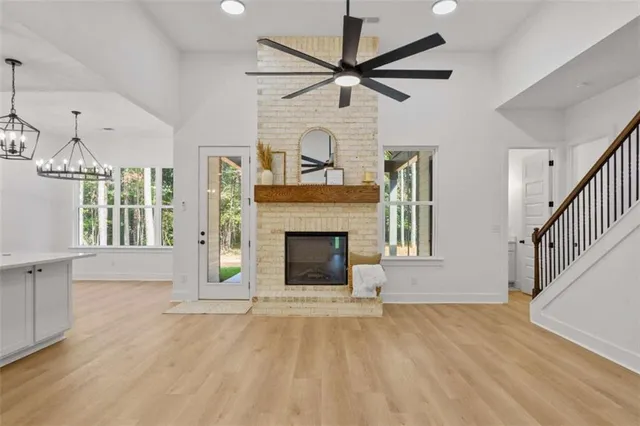 a large kitchen with stainless steel appliances granite countertop a sink a window and a stove