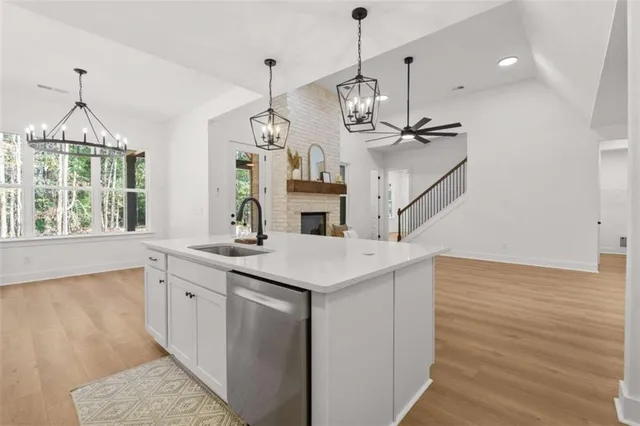 a kitchen with kitchen island stainless steel appliances a sink and cabinets