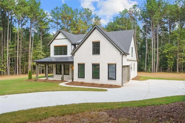 a front view of a house with a yard table and chairs
