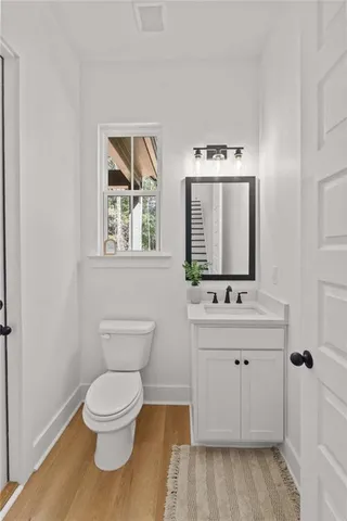a bathroom with a toilet a sink and a window
