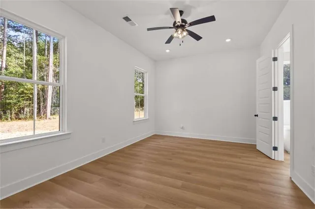 a spacious bathroom with a tub sink and mirror