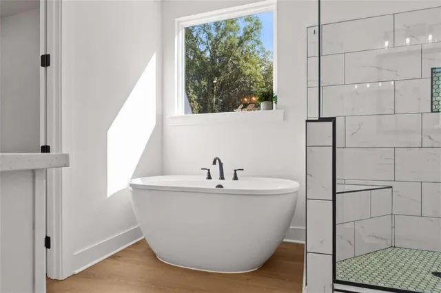 a bathroom with double vanity sinks a mirror and a shower