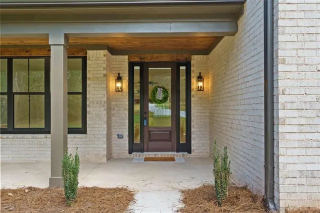 a front view of a house with a potted plant