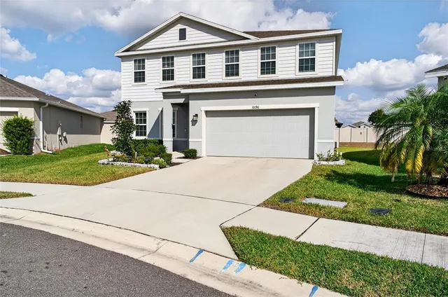 a front view of a house with a yard and garage