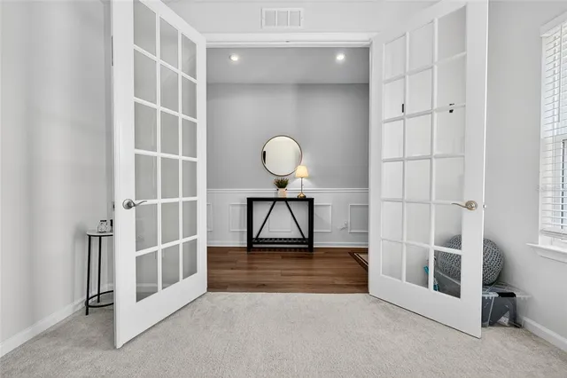 a bedroom with a large bed and a flat screen tv