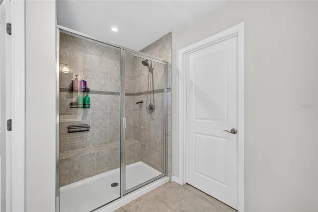 a bedroom with a bed and a ceiling fan