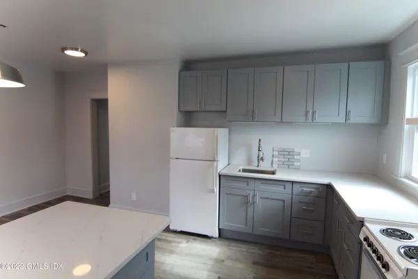 a kitchen with a sink a stove and cabinets