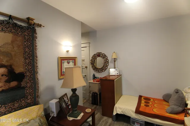 a living room with furniture and a mirror