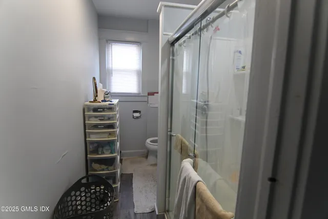 a bathroom with a toilet a sink and a window