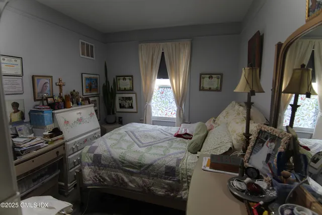 a bed room with a bed and a window